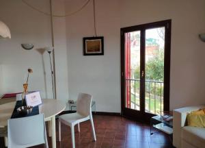 a living room with a table and a glass door at Villa Louise by Holiday World in Aci Castello