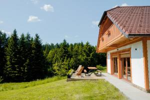 a wooden house with a picnic table next to it at Hiša Breza in Mozirje