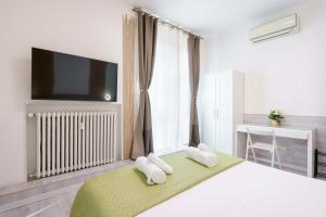 a bedroom with a large bed with two towels at Mirabilia Golden in Bologna