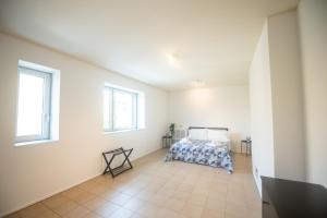 1 dormitorio con 1 cama y 2 ventanas en G59 LOFTS l Zona Stazione Centro l Netflix & Wi-Fi Fibra l en Parma