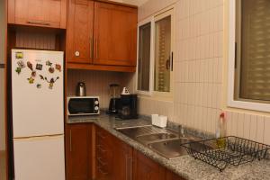 a kitchen with a white refrigerator and a sink at Santa Maria Main Street in Santa Maria +8 photos