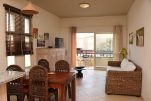 a living room with a table and chairs and a couch at Santa Maria Main Street in Santa Maria