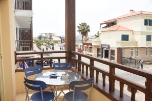 a balcony with a table and chairs and a view at Santa Maria Main Street in Santa Maria