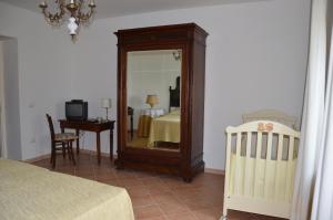 a bedroom with a mirror and a bed and a crib at Agriturismo Tenuta Buon Respiro in Orvieto