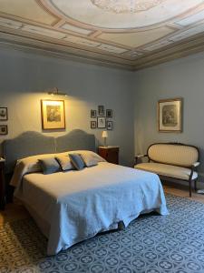 a bedroom with a large bed and a ceiling at Burlamacchi Villas in Bagni di Lucca