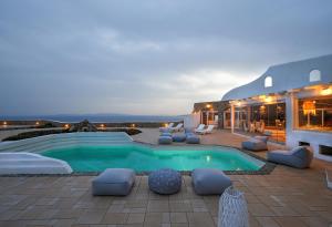 a villa with a swimming pool and a patio at Cliff Top 270 in Fanari