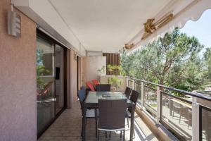 a balcony with a table and chairs on a balcony at 2-bedroom 2 min from the beaches with a terrace in Cannes