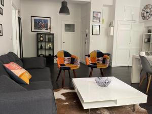 a living room with a couch and chairs and a table at Chez angy et manu in Marseille