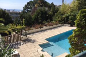 a swimming pool in a yard with a fence at PERFECT 3 bedrooms with terrace & pool in Cannes