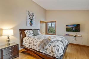 a bedroom with a bed and a lamp and a window at Skyledge in Beech Mountain