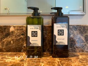 two bottles of soap sitting on top of a counter at SBR2B Hozem KK1184 Apartment CBD in Kota Kinabalu