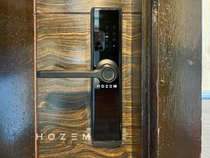 a wooden door with a lock on it at SBR2B Hozem KK1184 Apartment CBD in Kota Kinabalu +4 photos