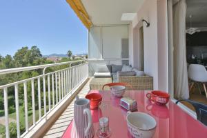 a pink table on the balcony of a house at Facing the sea modern terrace near the beaches in Cannes