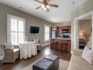 a living room with a table and a kitchen at Southern Elegance Estate in Savannah