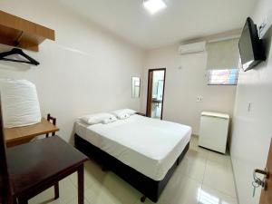 a bedroom with a bed and a television in it at Nav Park Hotel in Naviraí +31 photos