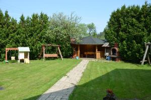 a yard with a house and a playground at Magurka Rycerka Górna in Rycerka Górna