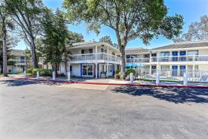 オークランドにあるMotel 6-Oakland, CA - Embarcaderoの前に木々がある大きな白い建物