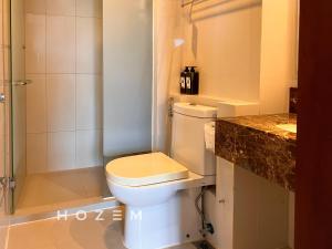 a bathroom with a toilet and a shower and a sink at 1BR1B Hozem KK0951 Apartment CBD in Kota Kinabalu