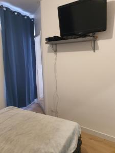 Plat Gousset - RDC في غرانفيل: غرفة نوم مع تلفزيون بشاشة مسطحة على جدار