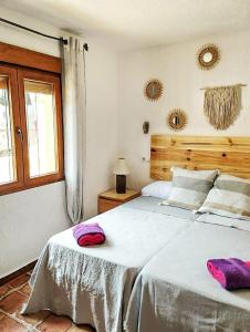a bedroom with a bed with two towels on it at Cala Moraig in Benitachell