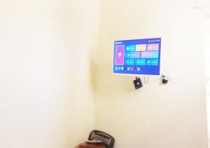 a flat screen tv hanging on a wall at Studio near the sea for surfing lovers welcome in Safi