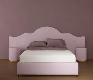 a white bed with two pillows and two lamps at Castiglioncello Suite in Castiglioncello