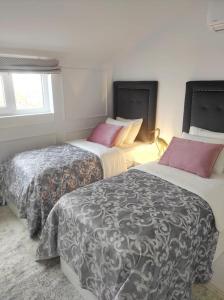 a bedroom with two beds and a window at Penthouse Las Americas first line de lux in Arona +20 photos