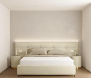 a white bedroom with a large white bed at Castiglioncello Suite in Castiglioncello