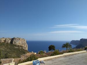 a view of the ocean from the side of a mountain at Cala Moraig in Benitachell