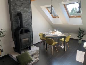 a dining room with a stove and a table with chairs at Relax & Active Apartment Tábor in Tábor