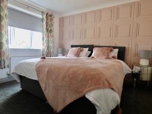 a bedroom with a large bed and a window at Millies Holiday Home in Blackpool