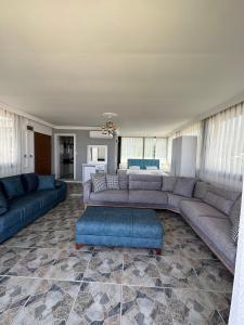 a living room with two couches and a blue couch at sandhill otel in Kemer