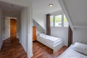 a bedroom with two beds and a staircase at Grote vakantiewoning 190m2! op ruim- en groen perceel in Otterlo