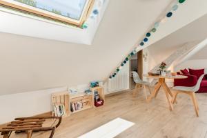 a living room with a table and chairs in a attic at Coquet T2. Exceptionnel entre lac et montagnes in Menthon-Saint-Bernard