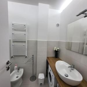 a white bathroom with a sink and a toilet at CASA FAUL con parcheggio vicino Alloggio turistico in Viterbo +65 photos