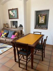 a living room with a wooden table and a couch at CASA LUCIO in Grosseto