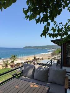 a couch sitting on a balcony overlooking the beach at sandhill otel in Kemer