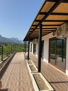 a building with a wooden deck with a roof at sandhill otel in Kemer