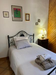 a bedroom with a bed with two towels on it at CASA LUCIO in Grosseto