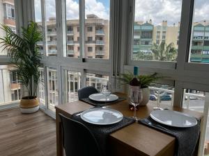 a dining room with a table and a large window at Lux Apartment BY NAMASTE ELITE in Torremolinos