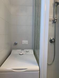 a bathroom with a white sink and a shower at Casa dei Fiordalisi in Milan