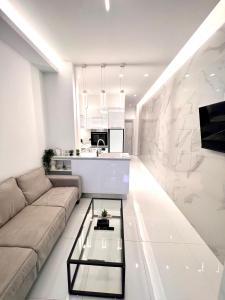 a living room with a couch and a table at Luxury Black and White Interior Apartments in Kalamata +20 photos