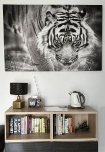 a black and white picture of a tiger on a wall at Apartmán Lodenica in Piešťany