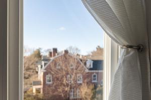 a window with a view of a building at Urban Oasis in beautiful East Rock Free Parking Yale adjasent in New Haven