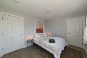 a bedroom with a bed with two shoes on it at Urban Oasis in beautiful East Rock Free Parking Yale adjasent in New Haven