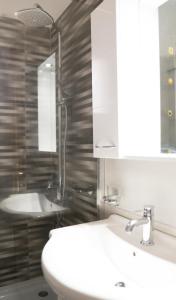 a bathroom with a white sink and a mirror at Raptis Guest House in Tsilivi