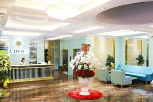 a lobby with a vase of flowers in the middle at Adina 3 Star Hotel in Danang