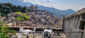 a view of a town on a hill with chairs at Pollino House in Morano Calabro