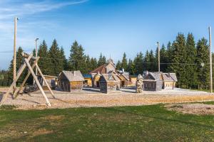 a playground with wooden play structures in a park at APARTMENTS ROGLA JURGOVO - Ski in Ski out in Lukanja