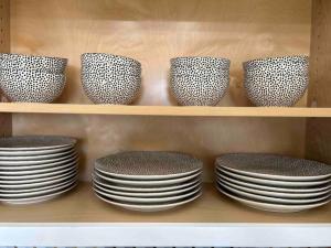 a group of plates and bowls on a shelf at Luxurious Home - Gameroom - Cowboy Pool in San Diego